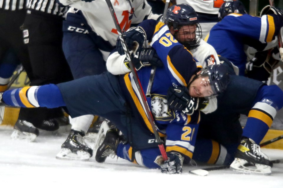 Lakehead captain Jordan King is tangled up in a scrum during a scrappy opening period against the Northland College Lumberjacks on Friday, Oct. 22, 2021 at Fort William Gardens. (Leith Dunick, tbnewswatch.com)