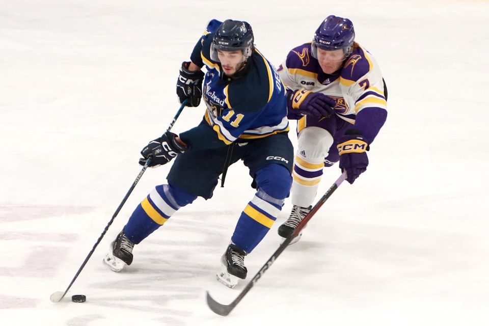 Laurier defenceman Bryce Kilbourne had three assists on Friday, Jan. 12, 2024 against Nicholas DeGrazia and the Lakehead Thunderwolves at Fort William Gardens. (Leith Dunick, tbnewswatch.com)