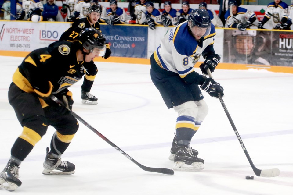 Lakehead's Colin Van Den Hurk, who later scored the game-winner, moves past Waterloo's Sam McKinney on Friday, Oct. 13, 2023 at Fort William Gardens. (Leith Dunick, tbnewswatch.com)