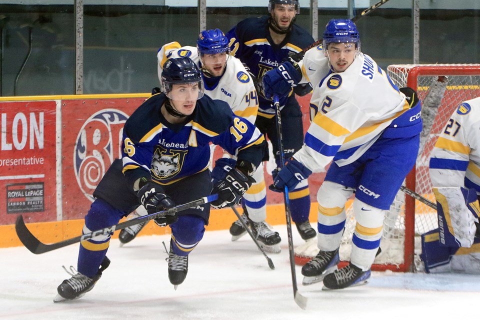 Lakehead's Spencer Blackwell (left) and TMU's Spencer Shugrue (2), who later scored the game-winner in overtime, tangle in front of the Bold net on Wednesday, Feb. 26, 2025. (Leith Dunick, tbnewswatch.com)