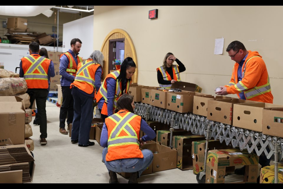 Tbaytel staff volunteers help pack up donations at Thunder Bay’s Regional Food Distribution Association on Dec. 4.