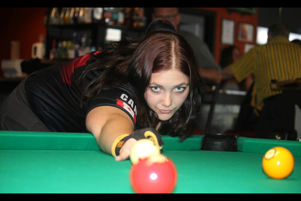 Amber Kolchew gets in a little practice at In the Corner Biliiards in St. Cathaines. The Thorold resident  is the Canadian Junior Billiards under-19 champion and is headed to the WPA World Junior Championships in Hamilton, New Zealand, in September.