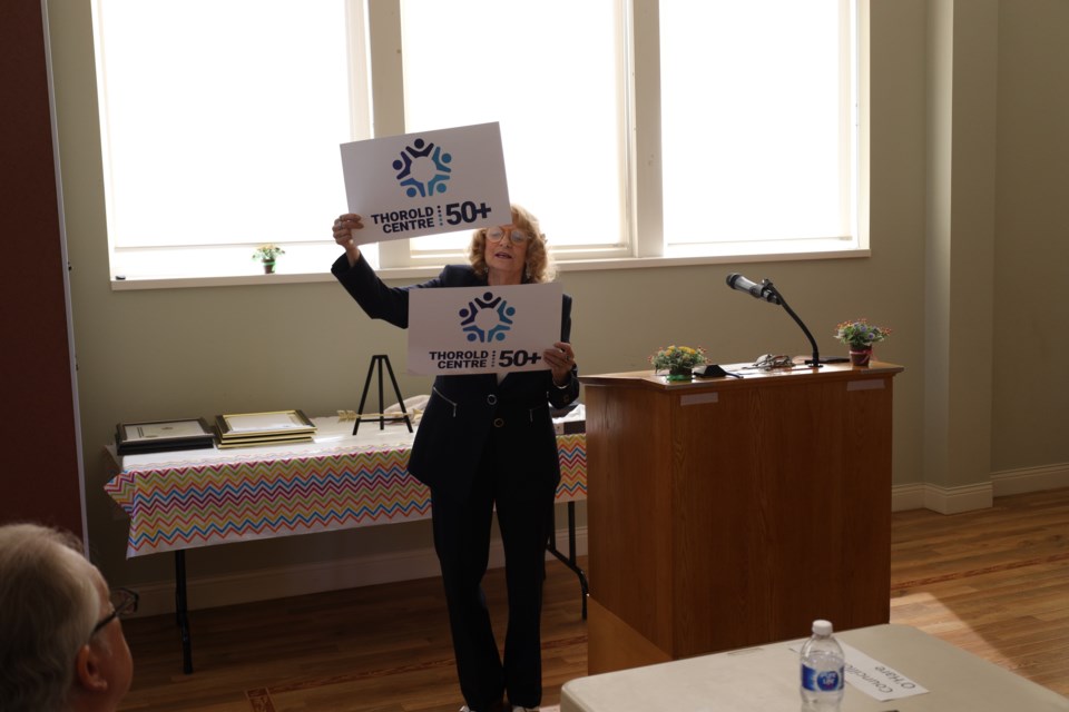 Brenda Bator, president of the Thorold 50+ Citizens Association, showing off the group's new name and logo. 