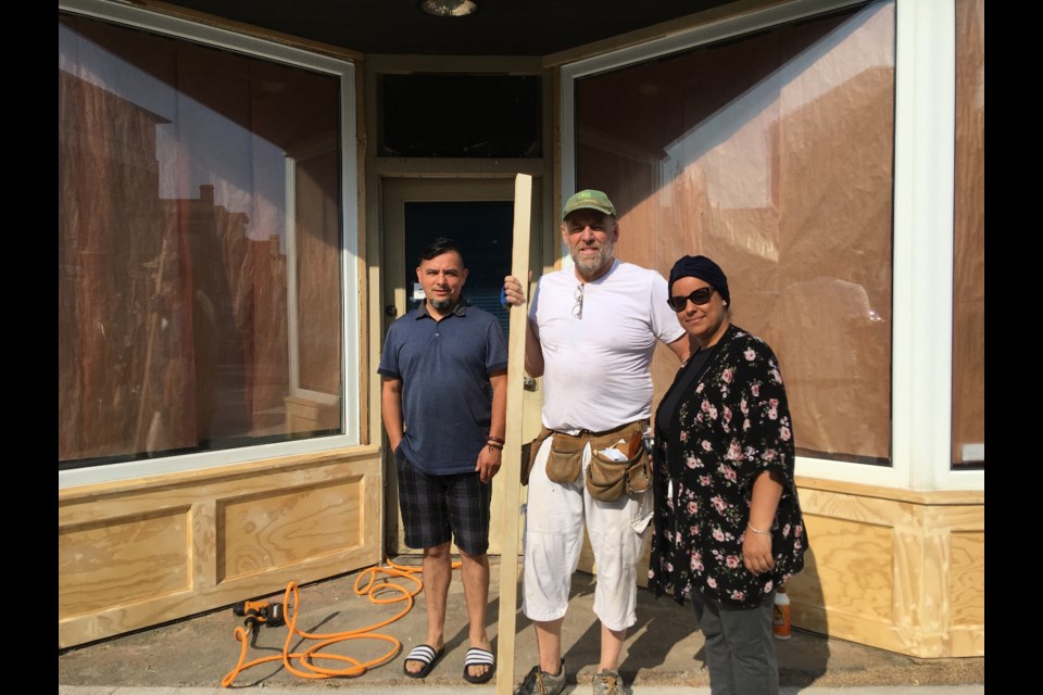 New building owners Juan Asenjo and Zahra Anzza, and their contractor Owen Juhlke (middle)