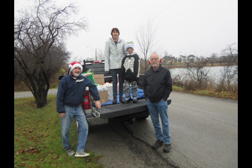 Mike Scofield, Helene Miller, Randy Paget and grandson Caleb collected the donations.