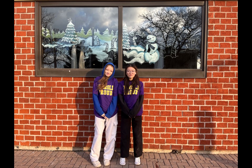 TSS students Cassidy Senior and Emily Ngo have given the windows of the Moose and Goose a Christmas makeover.