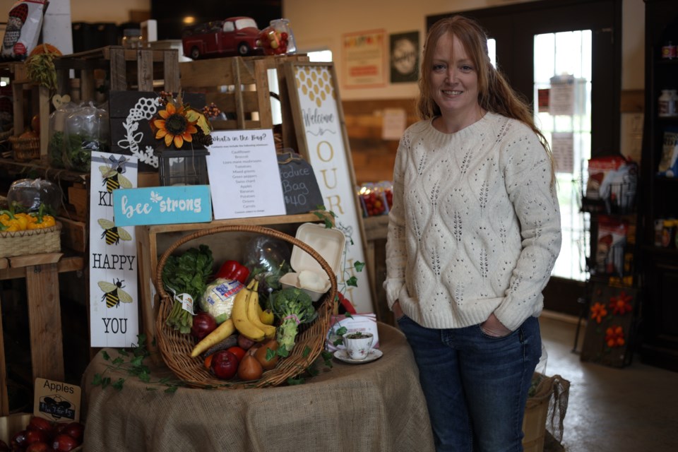 Renee Delaney with one of the produce bags Small Scale Farms sells.