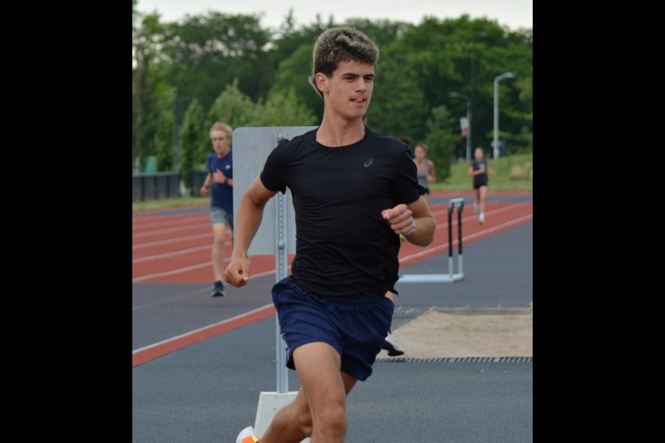 Virgil teen Andrew Bayne running on the track.