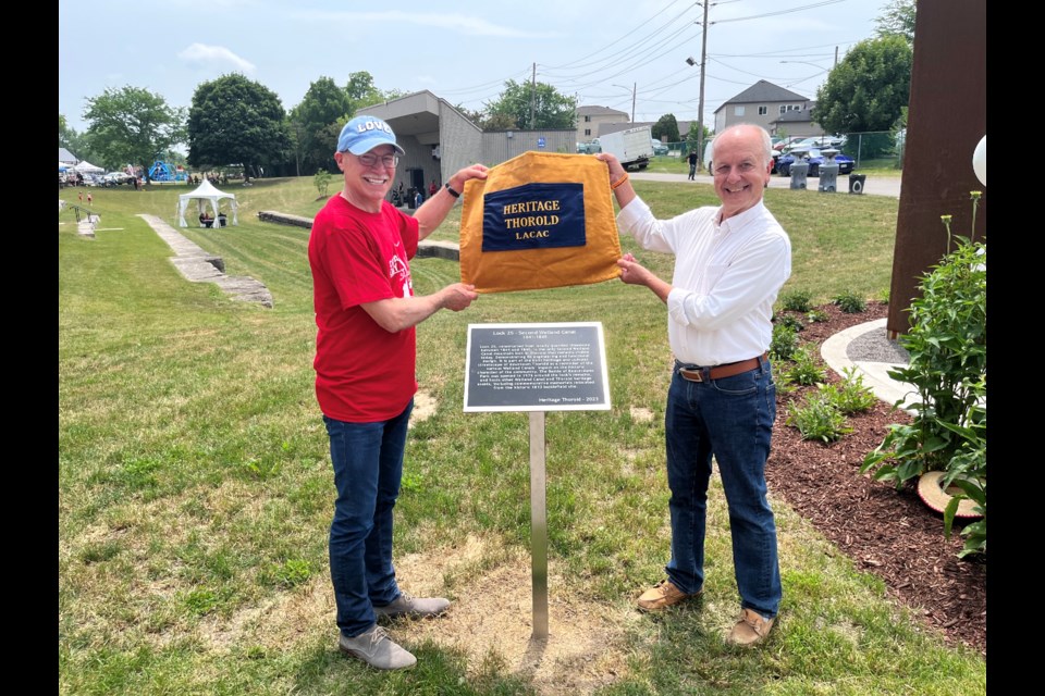 Councillor Tim O'Hare and Heritage Committee members Joe Prytula unveiled the plaque of the heritage site. Lock 25 is one of the original locks from the Second Welland Canal. The exposed stonework is often used as seating during concerts at the bandshell.