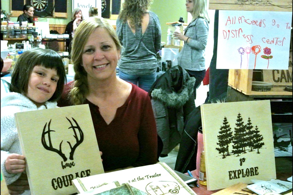 In memory of her nephew, who succumbed to suicide five years ago, Tammy Collins-Rivers—assisted by her daughter, Angel—donated all proceeds from her custom wooden signs to the Distress Centre. Cathy Pelletier/ Thorold News