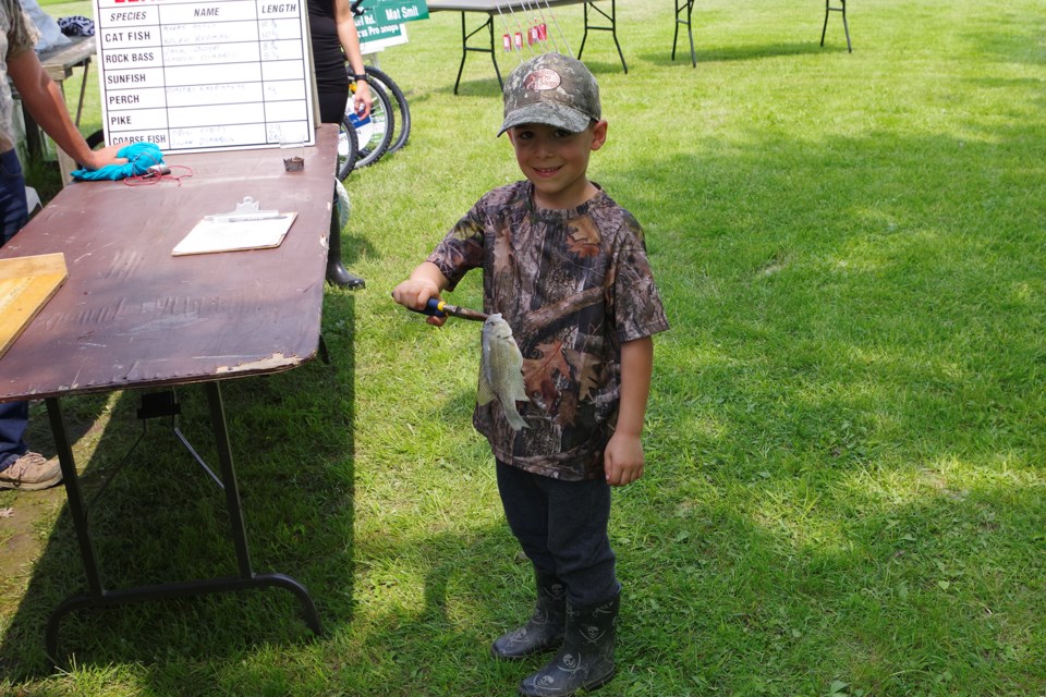 Brady Biamonte, age six, weighed in his entry at the Kids' Fishing Party last Saturday. Bob Liddycoat / Thorold News