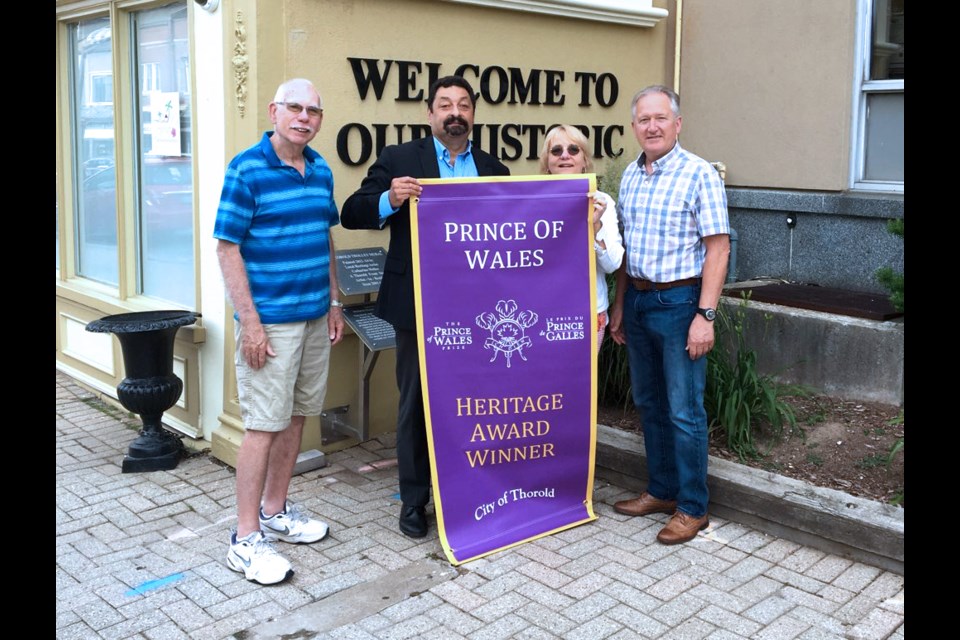 The Prince of Wales Heritage Flags have been raised on Front St. Pictured receiving them are (l-r) Councillor Fred Neale, BIA Chair Serge Carpino, Thorold Tourism Agent Susan Morin, and Mayor Terry Ugulini. Submitted Photo