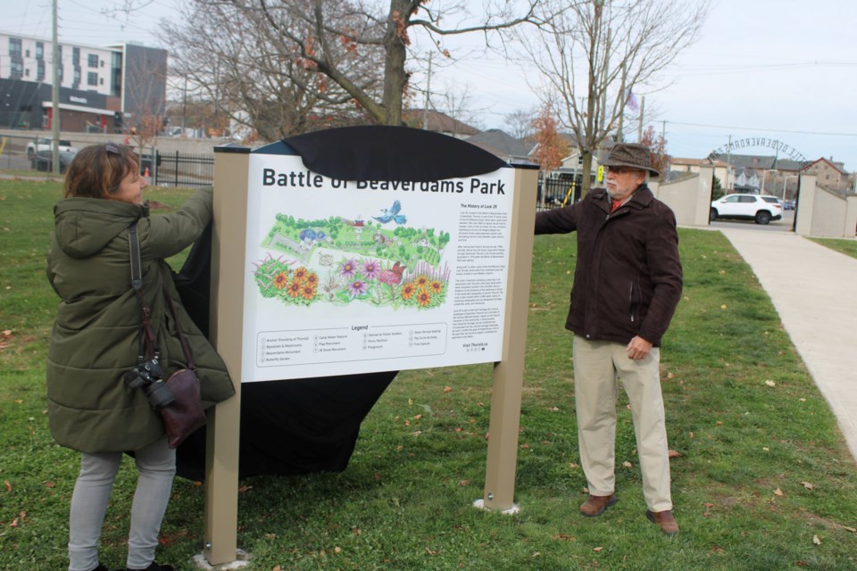 Natalie Stickles, left, community relations specialist for the City of Thorold, and artist Anton Gosley unveil a new wayfinding map of the Battle of Beaverdams Park on Nov. 14.