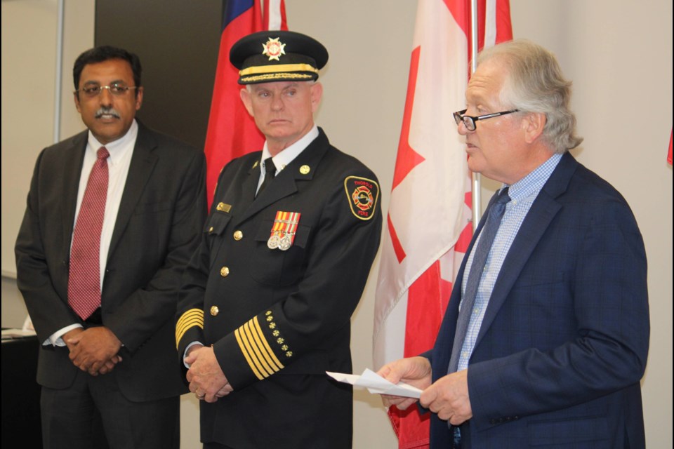 CAO Manoj Dilwaria and Fire Chief Terry Dixon listen at Thorold Mayor Ugulini addresses firefighters at an awards ceremony held at Station 1 on Nov. 13.