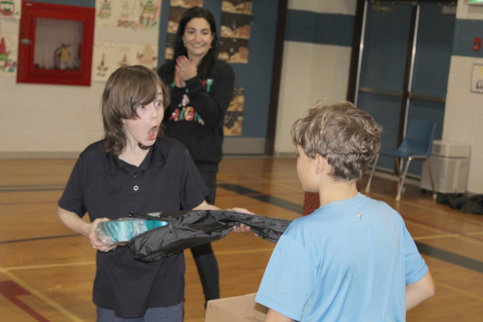 Roxton Turpin, left, got excited when he and Nico Nardamgeli open a package containing 24 new ukuleles for the music program at Our Lady of the Holy Rosary School in Thorold Thursday. The ukes were a part of a gift of musical instruments from the Music Gives Movement run by the Niagara Conservatory of Music.