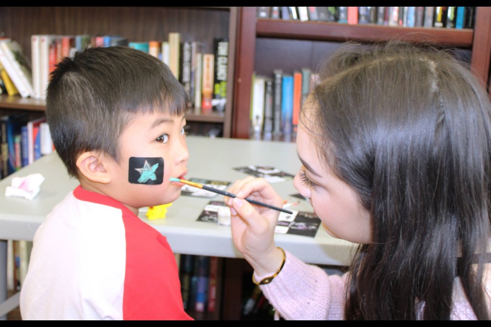 Ryan Duong, 5 from Thorold, has his face painted by Guzel Kaharjan, a student volunteer from Thorold Secondary School Saturday at the Thorold Centre 50+. The centre was hosting its second annual Seedy Saturday event, which included a seed exchange, vendors, a guest speaker and activities for kids.