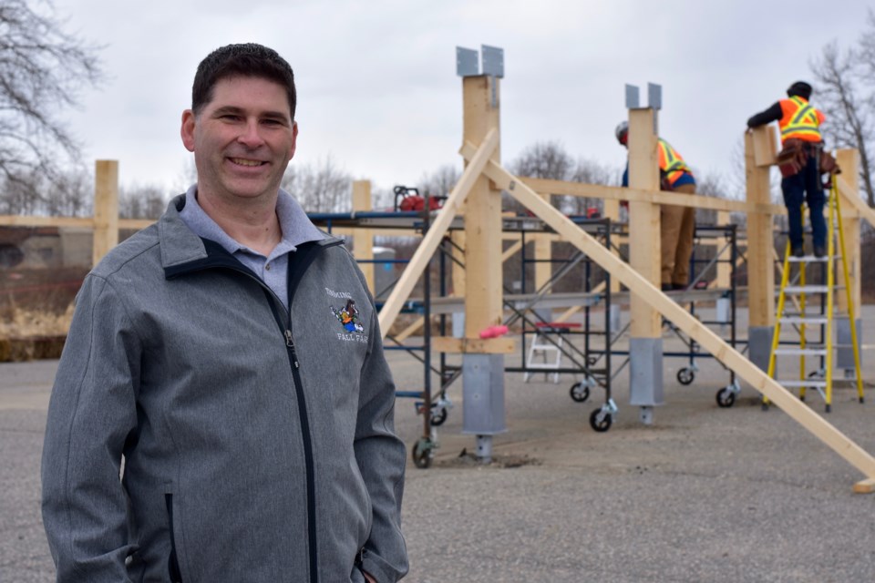 Porcupine District Agricultural Society president Rock Whissell with the new pavilion going up to house the weekly farmers' market.