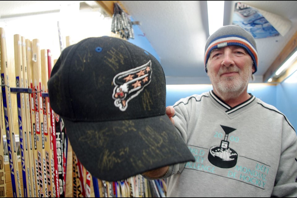 Mike Mulryan packs up his memorabilia at Quinn Sports, including this Washington Capitals hat signed by the team when Timmins' Alex Henry was on it. Maija Hoggett/Timmins Today