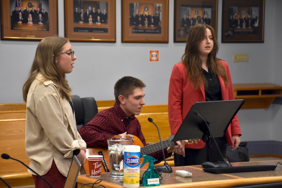 École secondaire catholique Thériault Grade 11 student Méa Dion and Grade 12 student Kiersten Trottier sing O'Canada for Timmins council at its Feb. 14, 2023, meeting. Grade 11 student Evan Nichols played guitar for it.