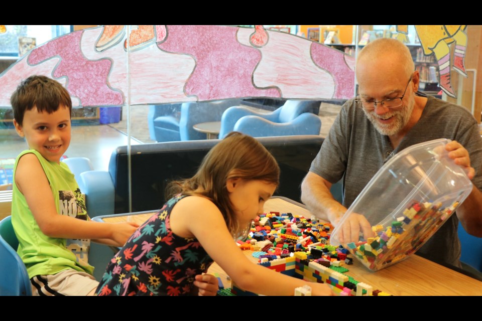 Ron Hanes said the Lego Zone at the Timmins Public Library was a great place to bring his grandchildren, Alex and Amelia Duguay.