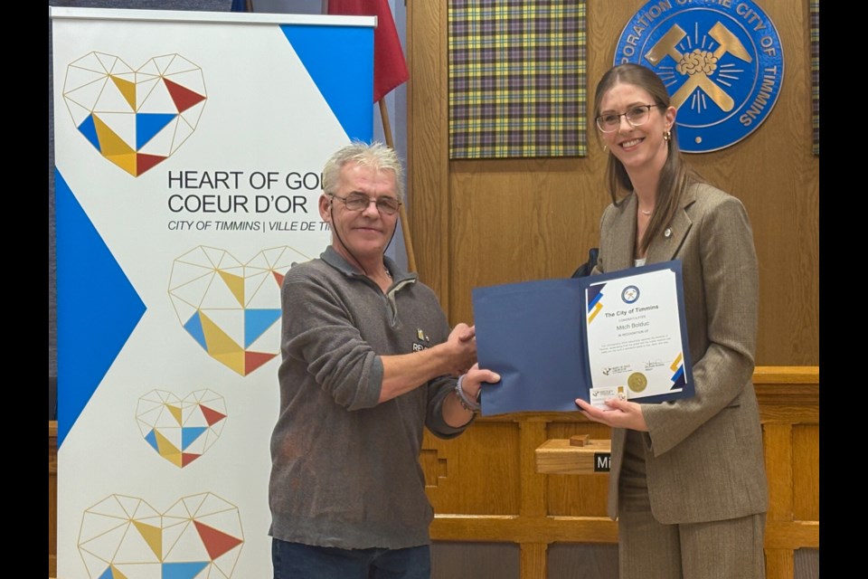 Mitch Bolduc picks up his Heart of Gold Civic Recognition Award from Mayor Michelle Boileau at the March 18 Timmins council meeting.