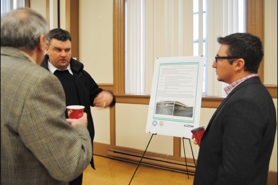 A member of the public (left) discusses with engineer Steve Roy from AECOM Consultants the improvements to Timmins Connecting Link  a 22 Km stretch of road from Kamiskotia Rd in the west to the old railway tracks in Porcupine in the east. Photo by Frank Giorno for TimminsToday