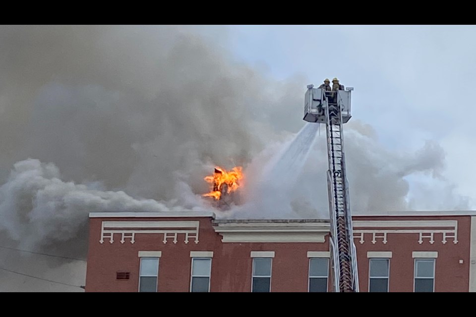 Aerial crews battle a fire on the roof of the Empire Complex at the corner of Spruce Street and Algonquin Boulevard.