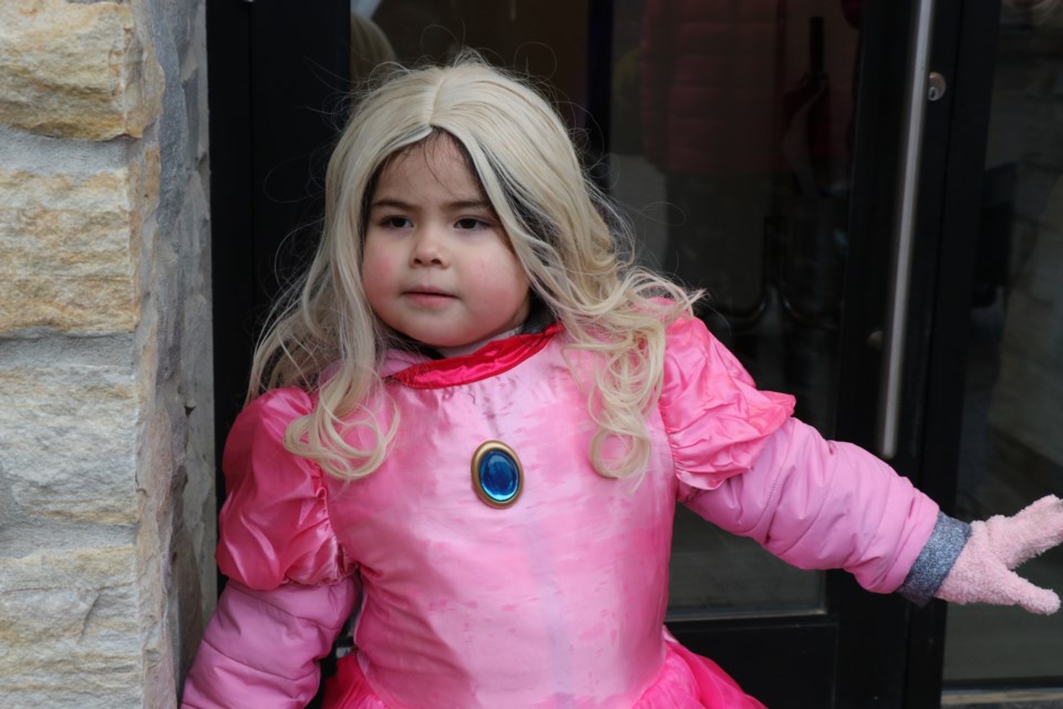 Ember Etherington stikes a pose before collecting some candy during the Downtown Timmins BIA trick-or-treat event.