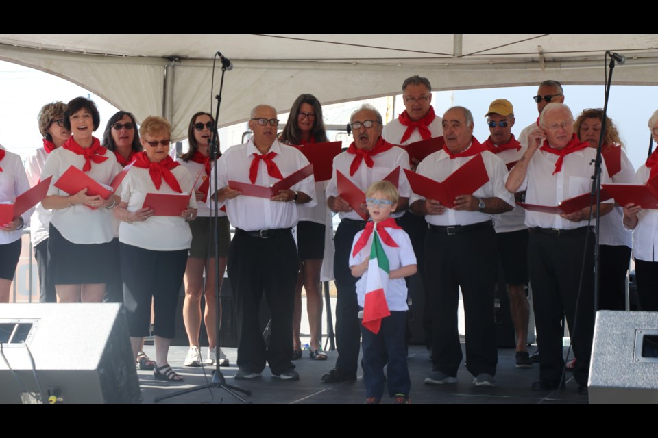 The Dante Club Choir with Eli Mascioli out front with the Italian flag, sang both the Canadian and Italian national anthems to start the Festa Italiana street party on Sunday, July 21.