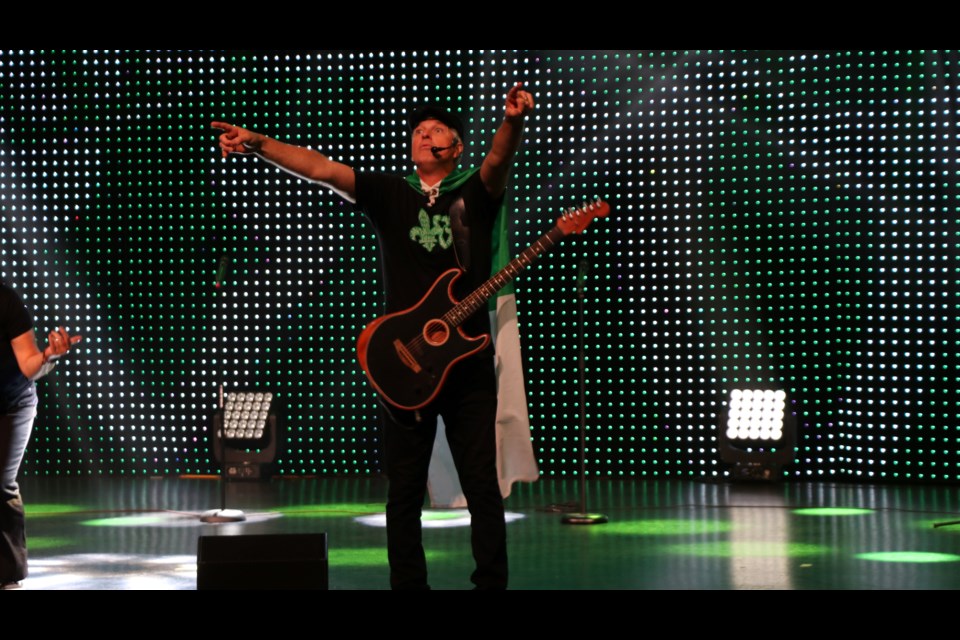 Brian St-Pierre signals the crowd to sing along at the Franco-Ontarian Flag Day celebrations.