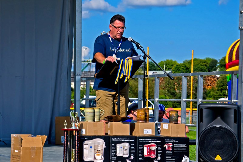 Guy Lamarche, event Co-Chair for the Great Canadian Kayak Challenge and Festival, presents awards to the winners of the day’s races.