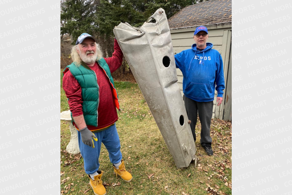 Mike Mulryan, left, and Dan Hway pick up items for the upcoming Bill Barilko display being put together by the Timmins Sports Heritage Hall of Fame.