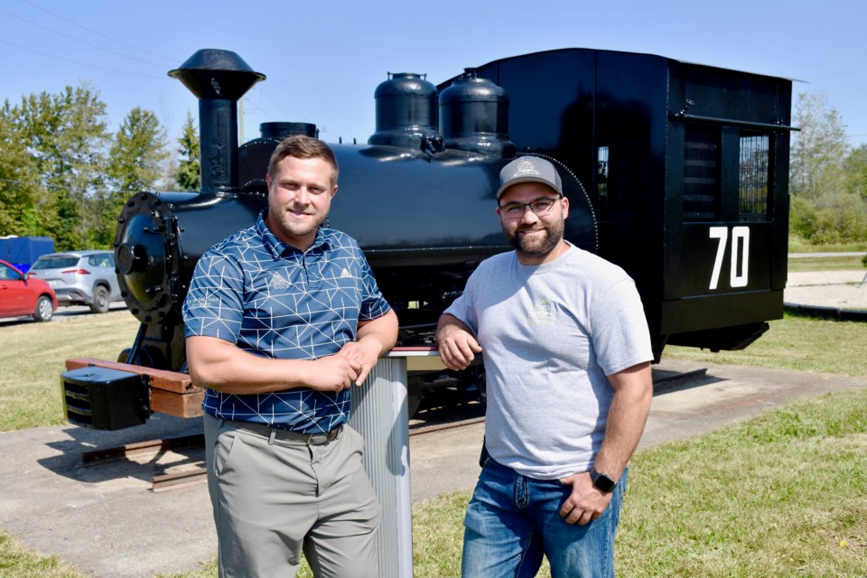 Gorf Manufacturing CEO Brad Norkum, left, and DJC Renovation owner/operator Donavan Cote refurbished the historic locomotive 70 and mine vault at the Whitney park.