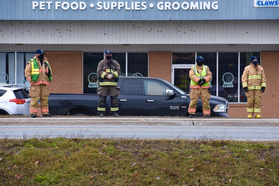 Timmins firefighters paid their respects while socially distanced across the street from the cenotaph. Maija Hoggett/TimminsToday
