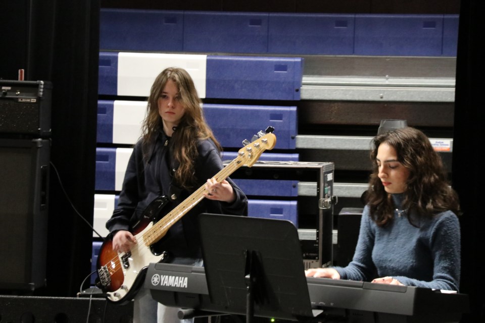 Mikayla Girard plays a solo during the Headframes cover of Something by The Beatles while Tara Kiani plays keyboards.