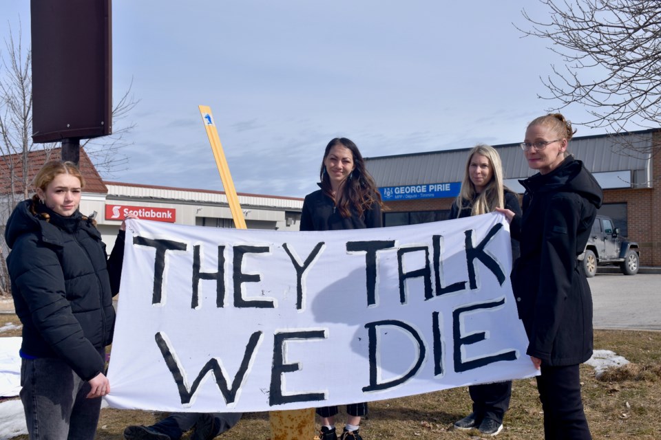 Demonstrators outside of Timmins MPP George Pirie's office on March 8, 2024. The group is calling on the province to act quickly to make sure that Safe Health Site Timmins receives funding to keep its doors open.