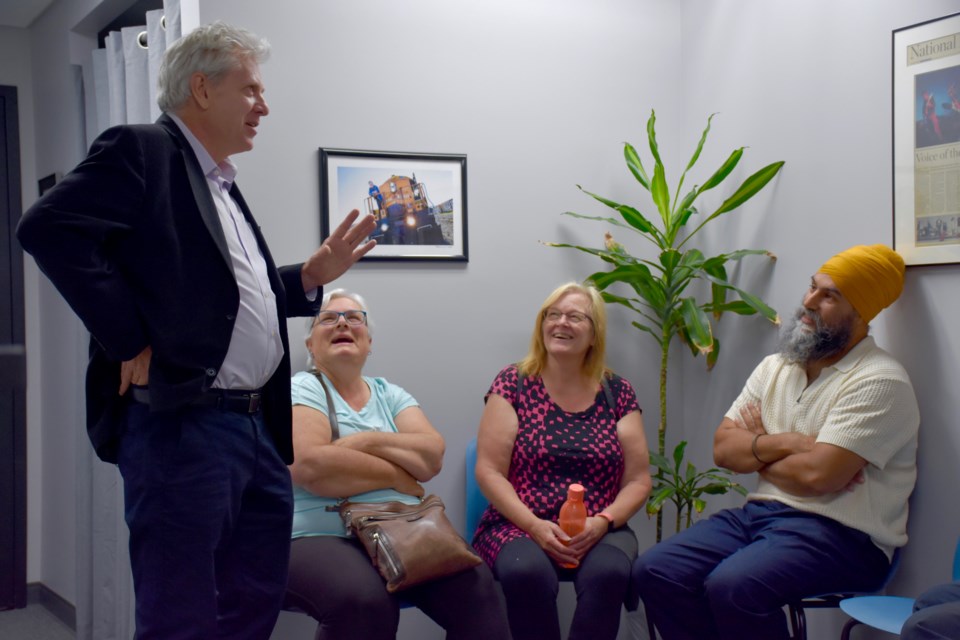 Federal NDP leader Jagmeet Singh, right, and Timmins-James Bay MP Charlie Angus talk with local constituents after a press conference on July 22, 2024.