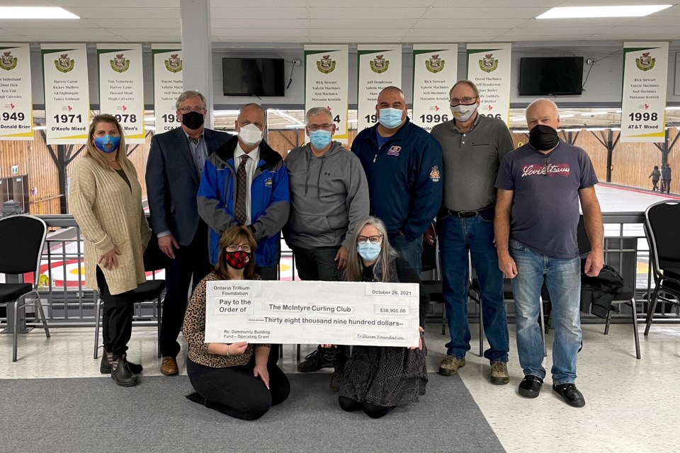 McIntyre Curling Club board members Rosanna Furletti, left, and Gord Cowie, Timmins MPP Gilles Bisson, club president Stephen Meunier, club vice president Tony Chilton, board members Randy Pickering and Jack Ouellette. In front, from left, is Kim Meunier, club manager, and Carole Horton, board member.