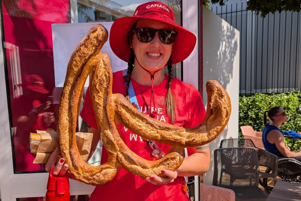 Meghan Mahon with baguettes in the shape of the Paralympic agitos.