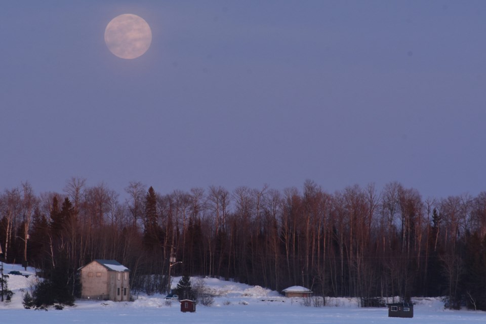 The full moon rises over the Tisdale pump house on the east shores of Porcupine Lake on March 13. 