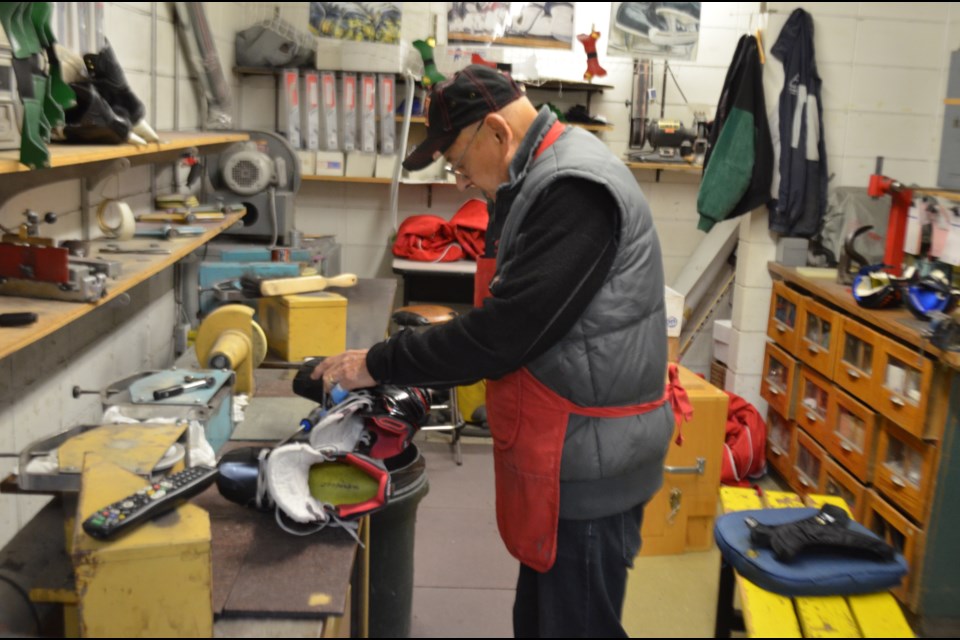 Dan 'Tixie' Hannigan is seen here sharpening skates at his shop in the McIntyre Arena. Timmins is mourning the loss of the local hockey icon. TimminsToday file photo