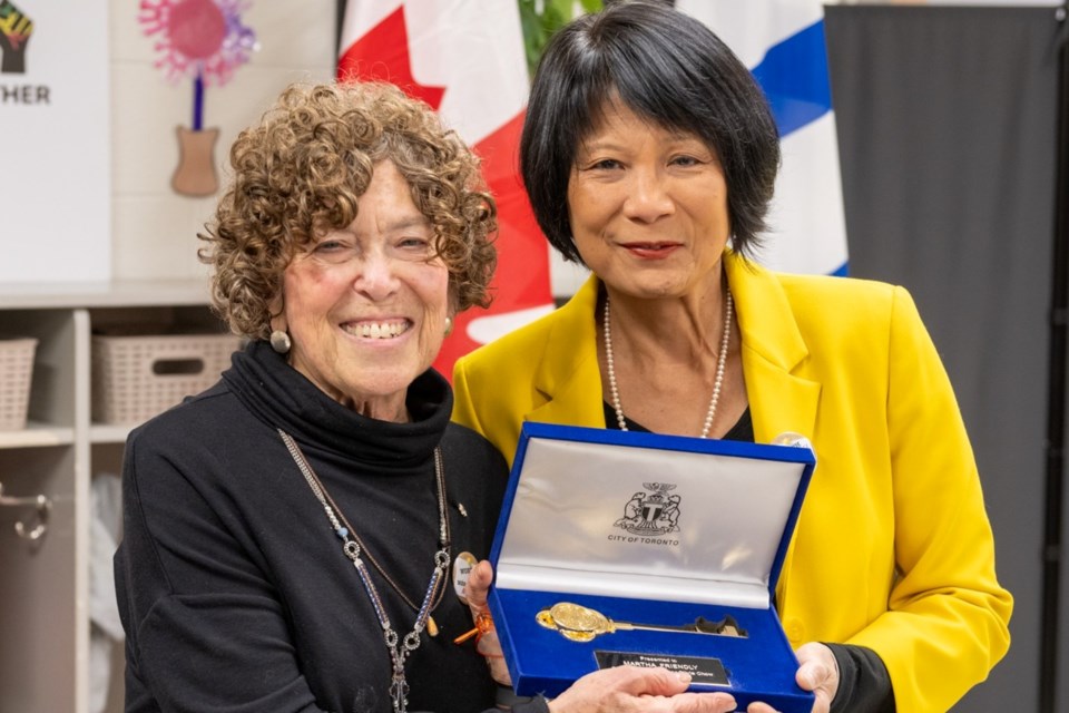 Mayor Olivia Chow (right) bestows the key to the city to Martha Friendly at the Blake Street Early Learning and Child Care Centre