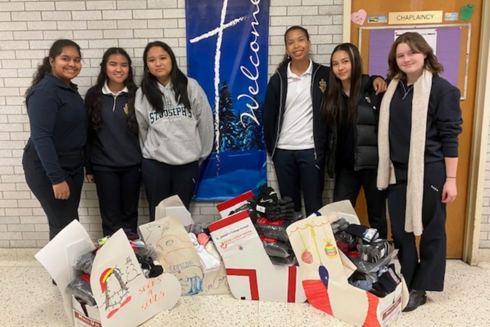 Students at St. Joseph's are pictured with the hundreds of brand-new socks they helped collect for the city's less fortunate.