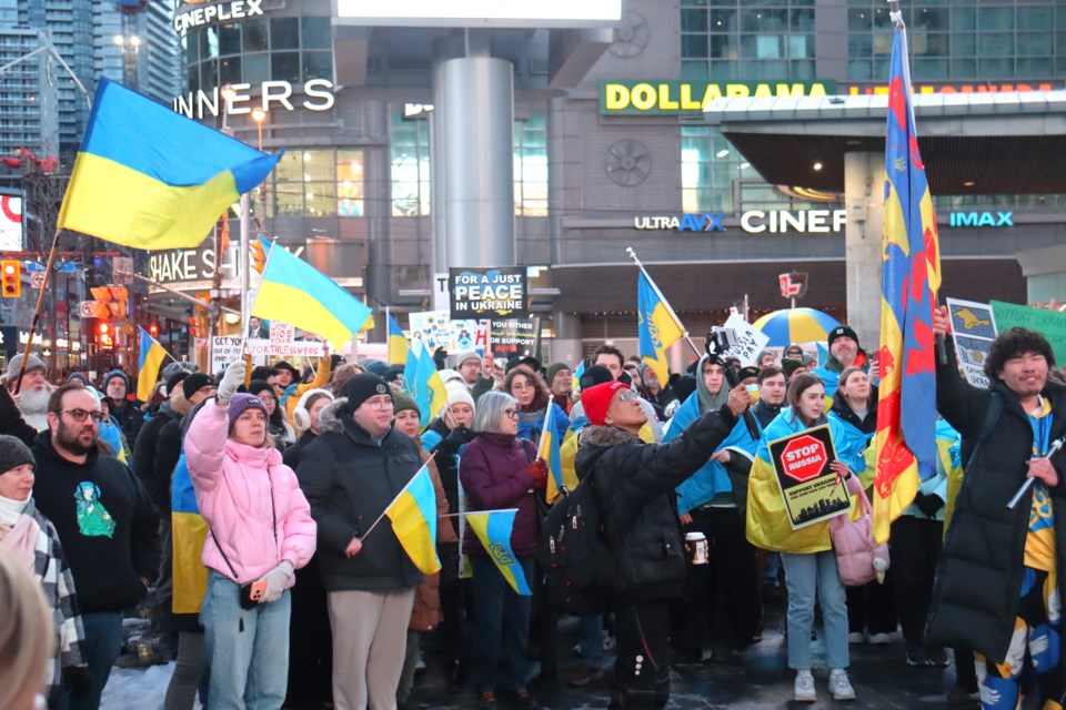 Hundreds chanted loudly at Dundas Square on Monday in support of Ukraine.