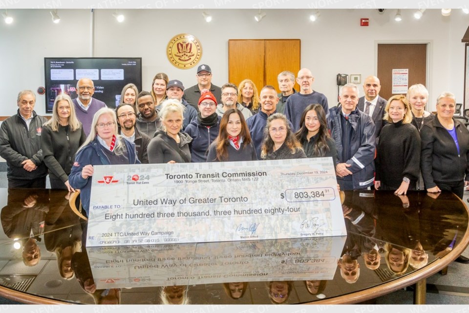 TTC workers present United Way Greater Toronto with a donation of $803,384.91 raised by TTC employees and pensioners.