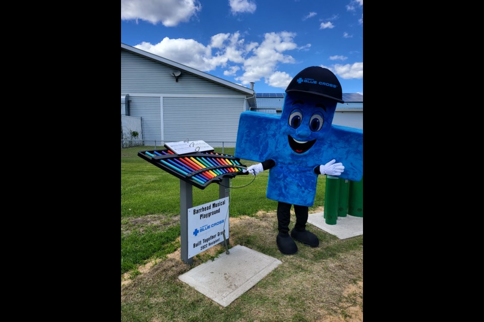 Blue, the Alberta Blue Cross Mascot, gives us a musical demo at the ribbon cutting ceremony.