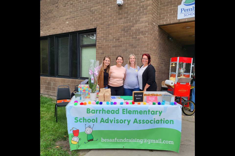 The Barrhead Elementary School Parent Council Advisory Association was set up at the Welcome event at Barrhead Elementary on August 27 sharing treats for the kids and talking about their plans. L-R Stacey Mack, Jamie Breitkreitz, Christine Carlson, and Stacey Loitz – chair.