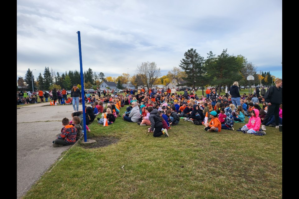 The elementary school students gathered outside to observe the ceremony for the Truth and Reconciliation Day event on Sept 27, many wearing their orange shirts in remembrance.