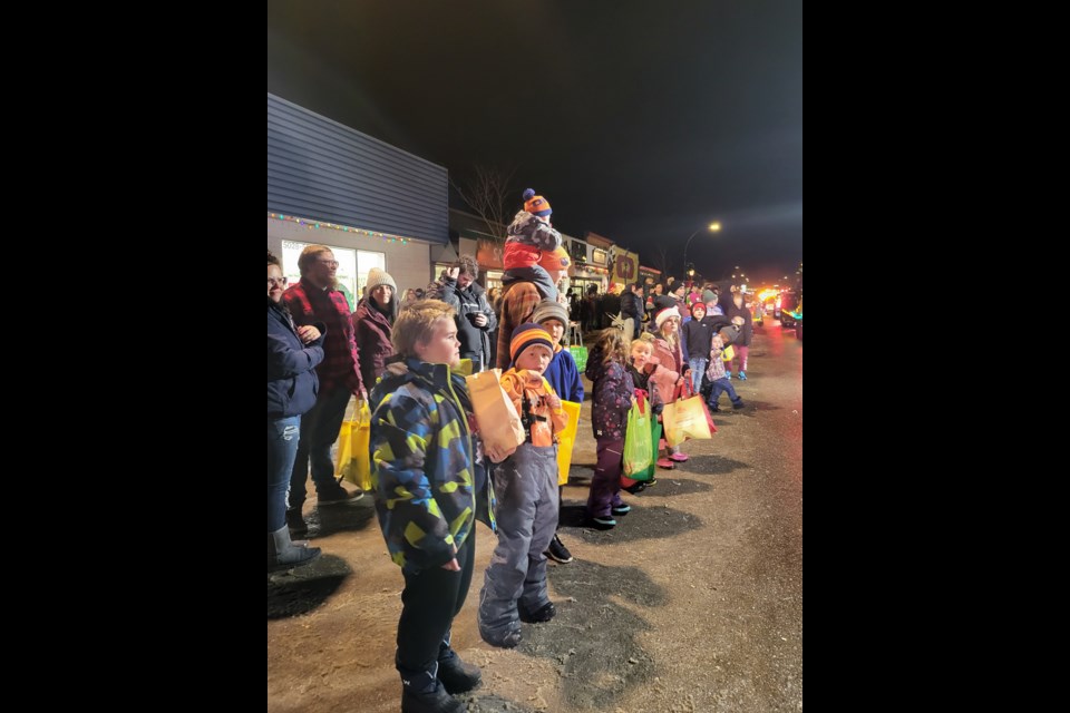 Enthusiastic boys catch the attention of parade candy throwers to fill their bags along the Barrhead Polar Parade route on Friday, Dec. 6. L-R TJ, Easton and Deagan.