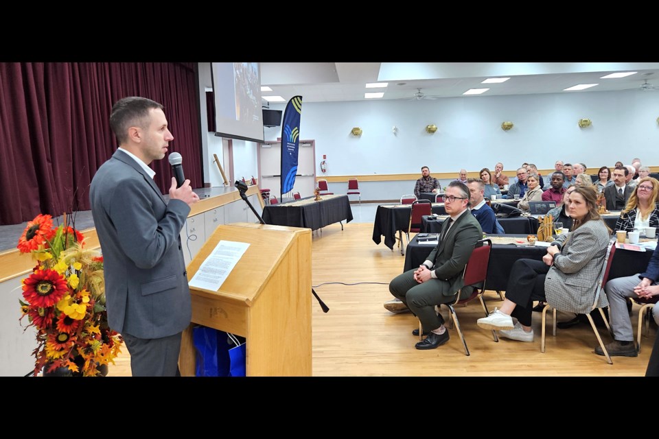 Members of the region’s business community and respective municipalities gathered Oct. 23 for the 2024 Business Breakfast, hosted in partnership by the Westlock and District Chamber of Commerce and the Westlock Economic Region at the Westlock Memorial Hall. This year’s event featured keynote speakers from the Town of Westlock, Village of Clyde and Westlock County, as well as a panel with Westlock Economic Region member and town councillor Murtaza Jamaly and Westlock Terminals CEO, Clifford Bell. Westlock mayor Jon Kramer speaks to the crowd during the business breakfast. Kristine Jean/WN    

